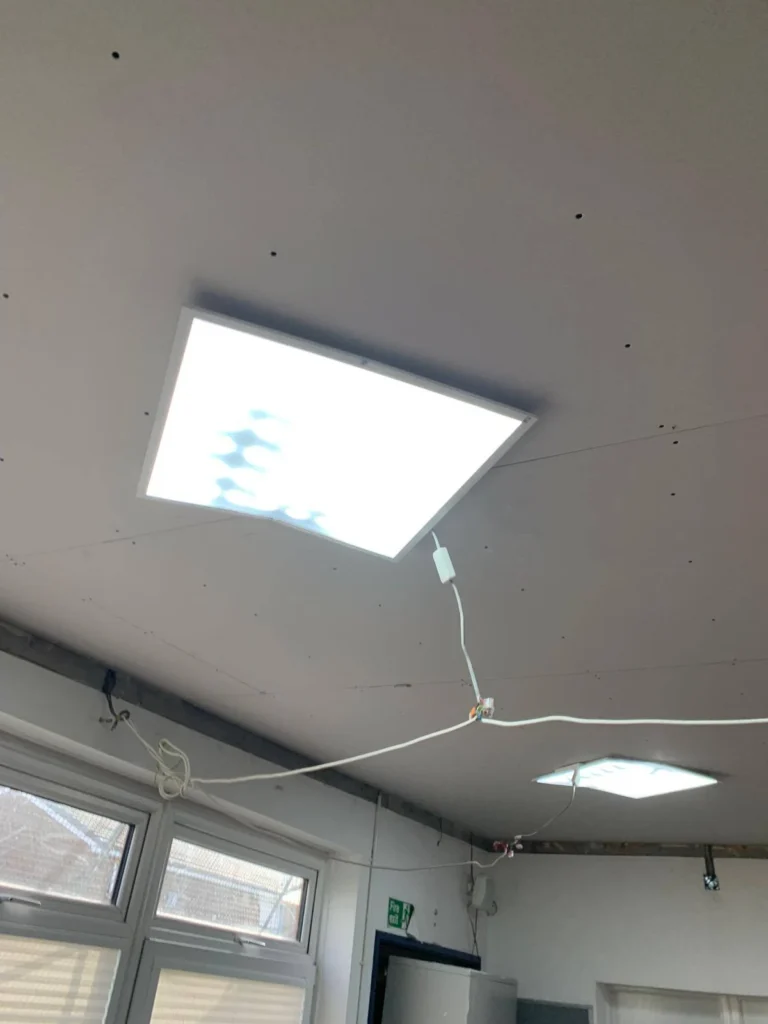New ceiling boards with openings for the lights.