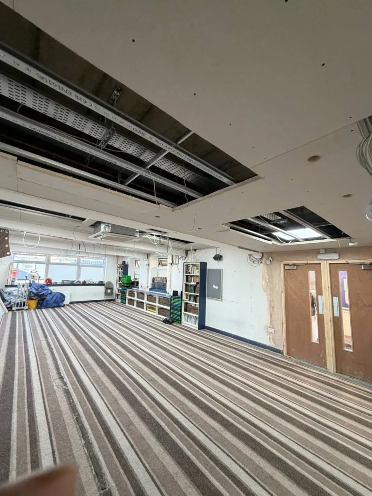 Ceiling-panel recesses taking shape across the musalla.