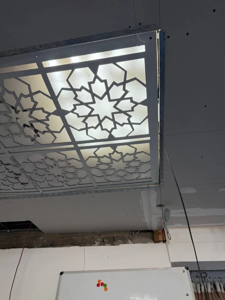 A decorative ceiling panel during fitting and lighting tests, before the ceiling finish.