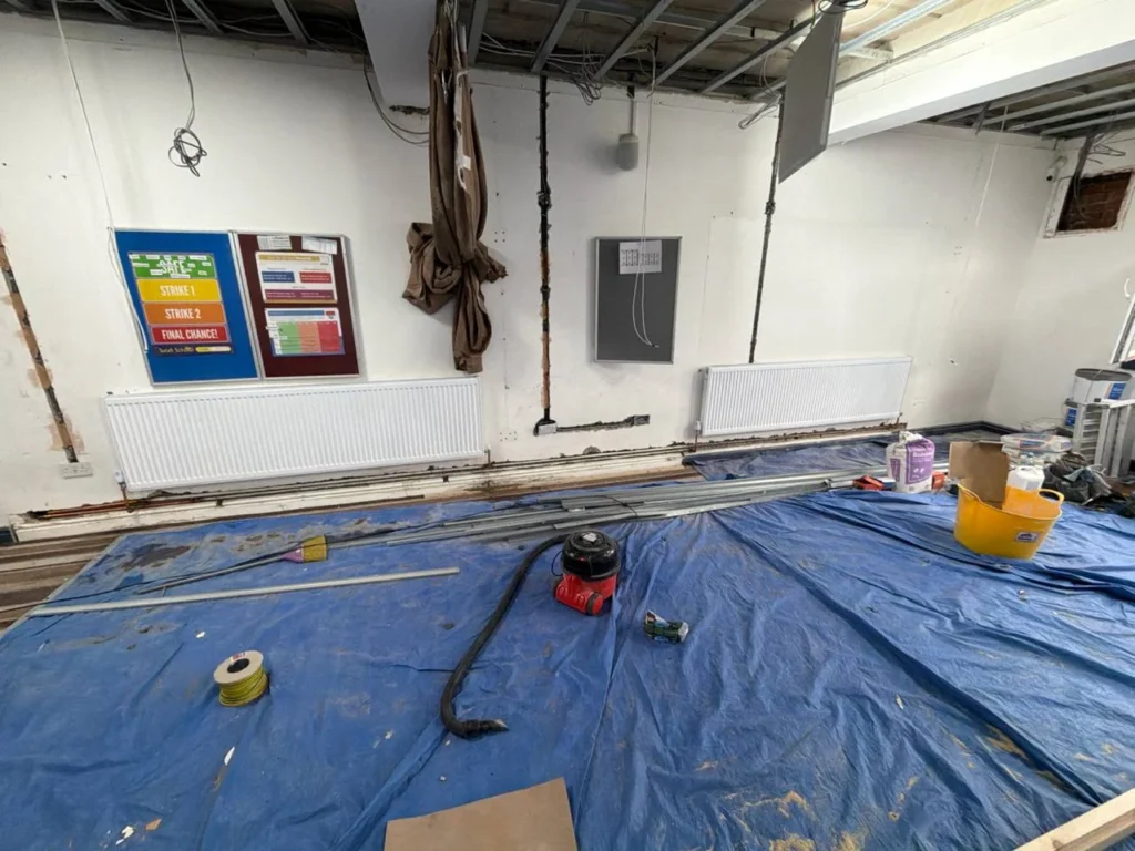 Earlier wall and pipework preparation.