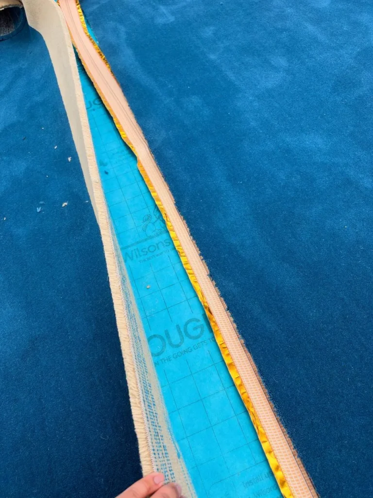 A seam folded back, showing the tape that joins the widths.