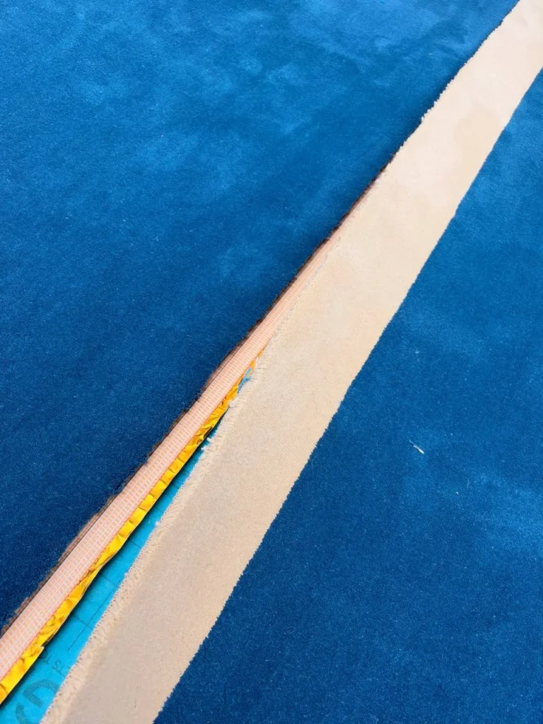 A row line lifted over the seaming tape beneath it.