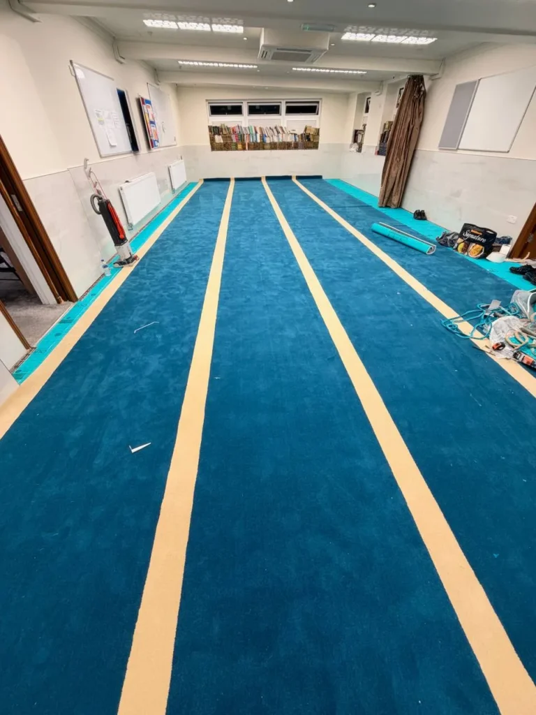 The prayer rows taking shape across the whole musallā.