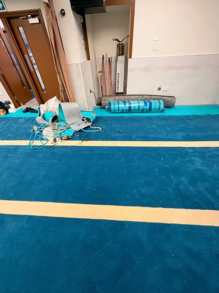 The new rows by the door, with the fitters’ tools and spare underlay.