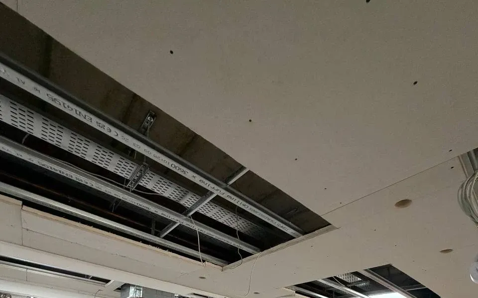 The unfinished ceiling in April, showing boarding and open recesses for the decorative panels.