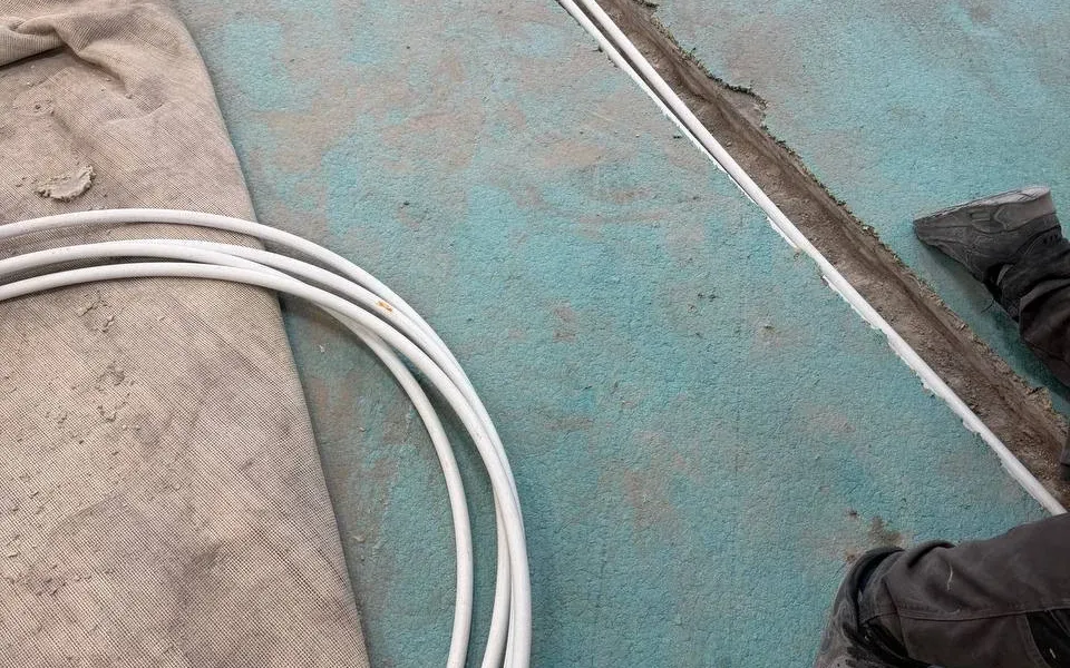 Channels and heating pipework beneath the windows during the July work.