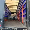 The new carpet rolls in the delivery vehicle.
