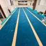 The prayer rows taking shape across the whole musallā.